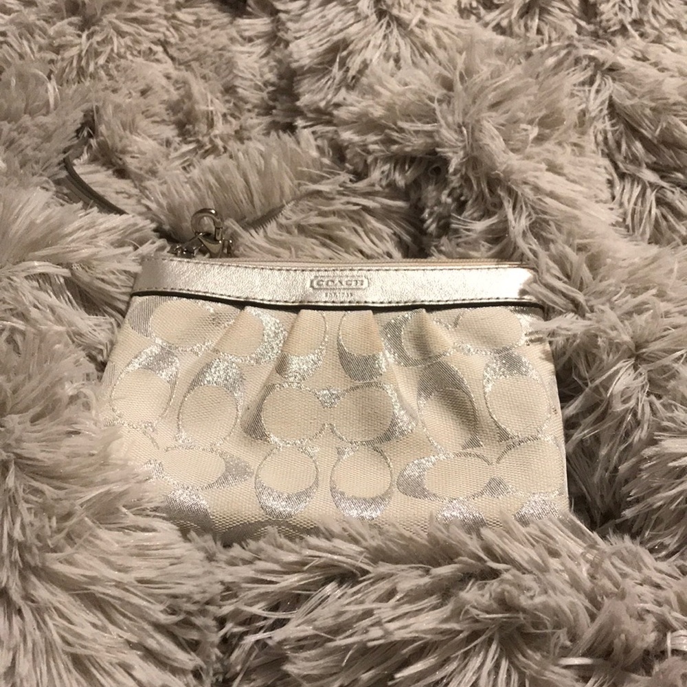 Silver coach wristlet clutch
